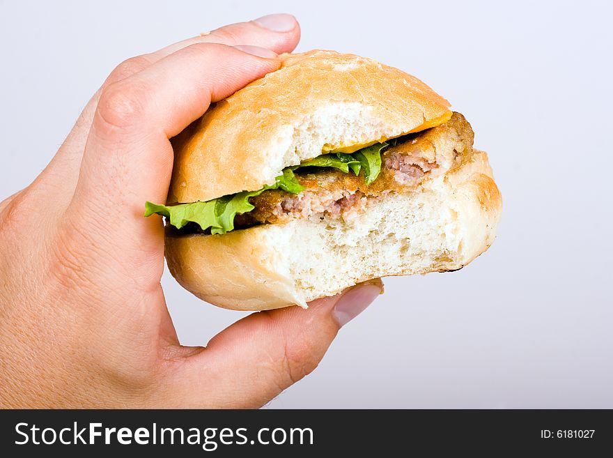 An image of hamburger in mans hand. An image of hamburger in mans hand