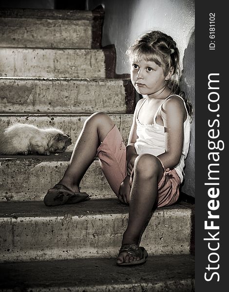 Little girl and kitten is sitting on stairs. Little girl and kitten is sitting on stairs