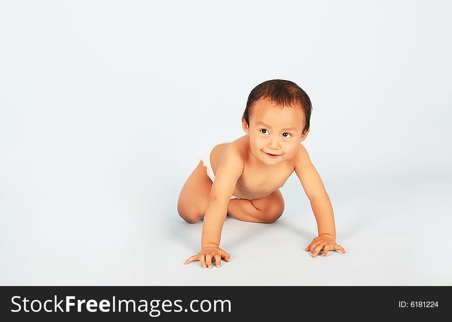 Cute baby crawling isolated shot over blue background