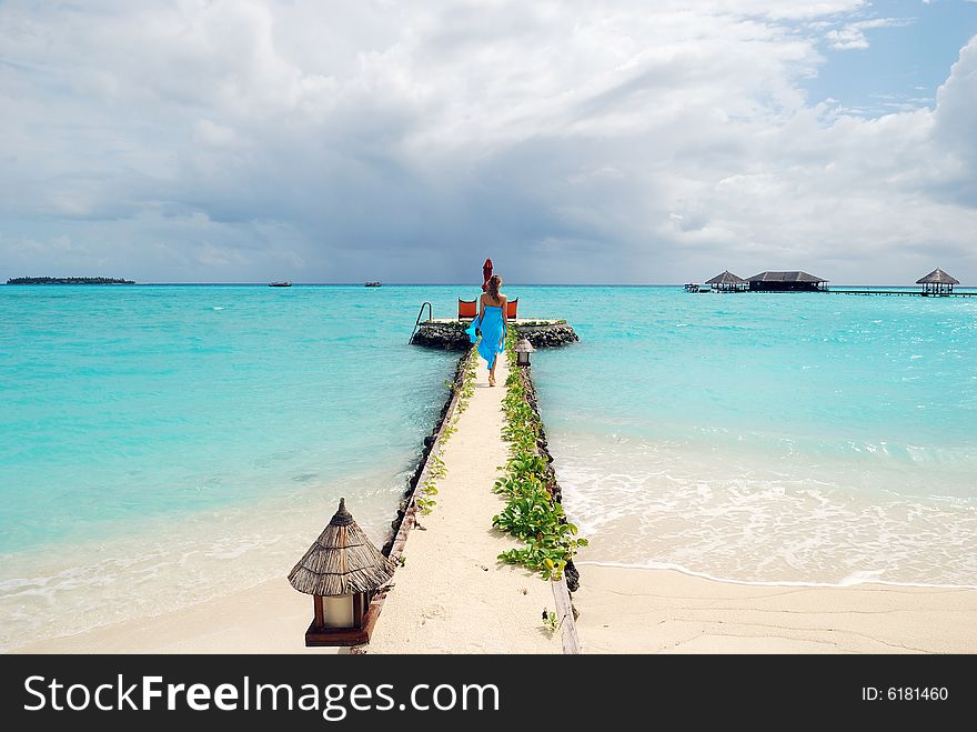 Happy woman walking on the tropical beach