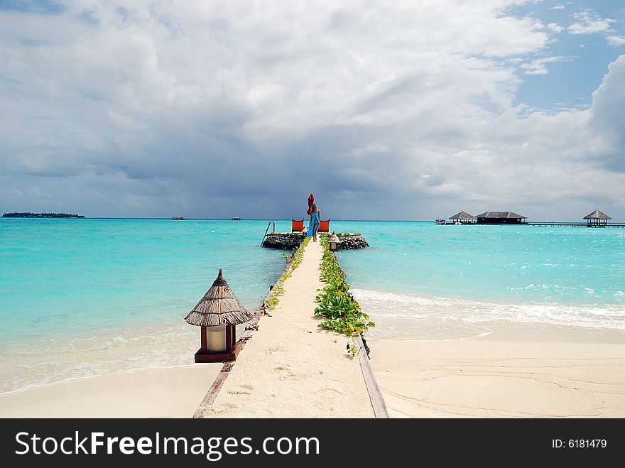 Happy woman walking on the tropical beach