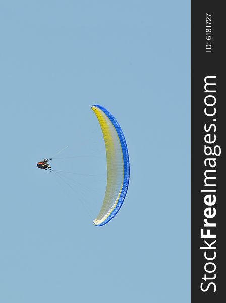 An accro paraglider pilot in the air. An accro paraglider pilot in the air