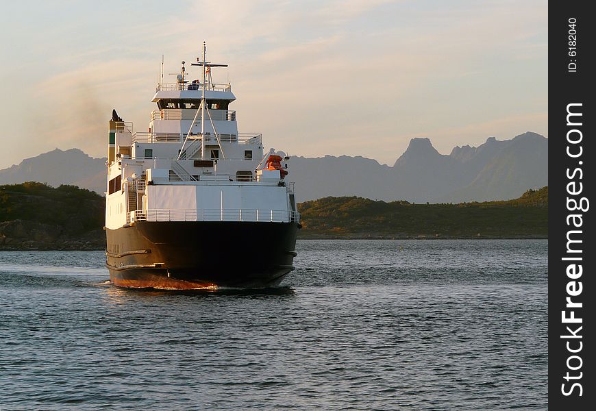 Norwegian ferry mooring at midnight in Fiskebol, Lofoten islands, norwegian arctic sea. Norwegian ferry mooring at midnight in Fiskebol, Lofoten islands, norwegian arctic sea