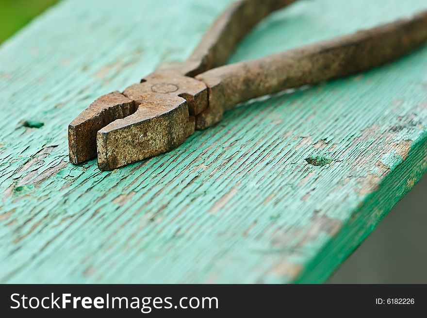 Old iron rusty pliers with blured background