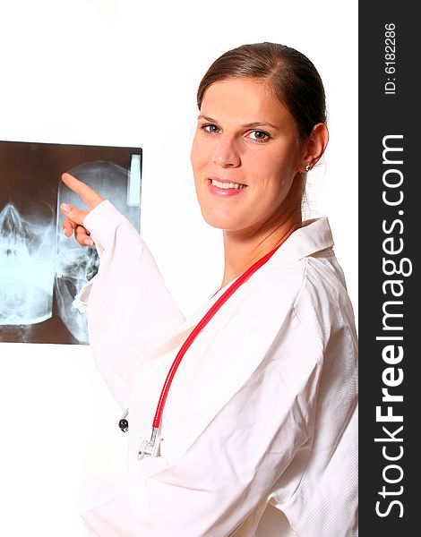 A beautiful young doctor with a red stethoscope and a xray image in the back. Isolated over white. A beautiful young doctor with a red stethoscope and a xray image in the back. Isolated over white.