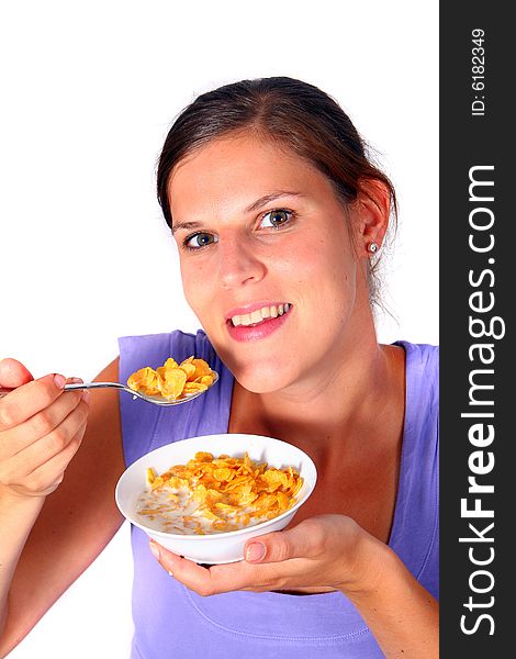 A young woman enjoys her crunchy cornflakes. Isolated over white. ** Note: Slight blurriness best at smaller sizes. A young woman enjoys her crunchy cornflakes. Isolated over white. ** Note: Slight blurriness best at smaller sizes