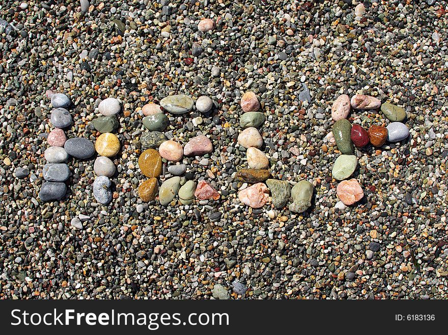 Help written with beach pebbles.