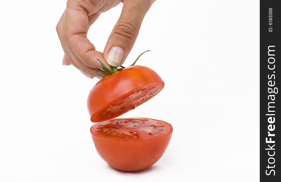 Tomato on a white background with hand