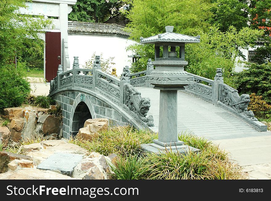 A bridge at Oriental Garden with green surroundings