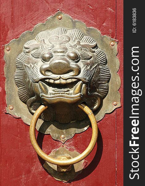 Close up of traditional oriental Chinese lion door knob. Close up of traditional oriental Chinese lion door knob