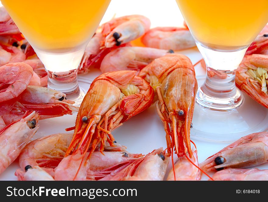 Beer in glass and snack - shrimps (prawns) in shells. Beer in glass and snack - shrimps (prawns) in shells.