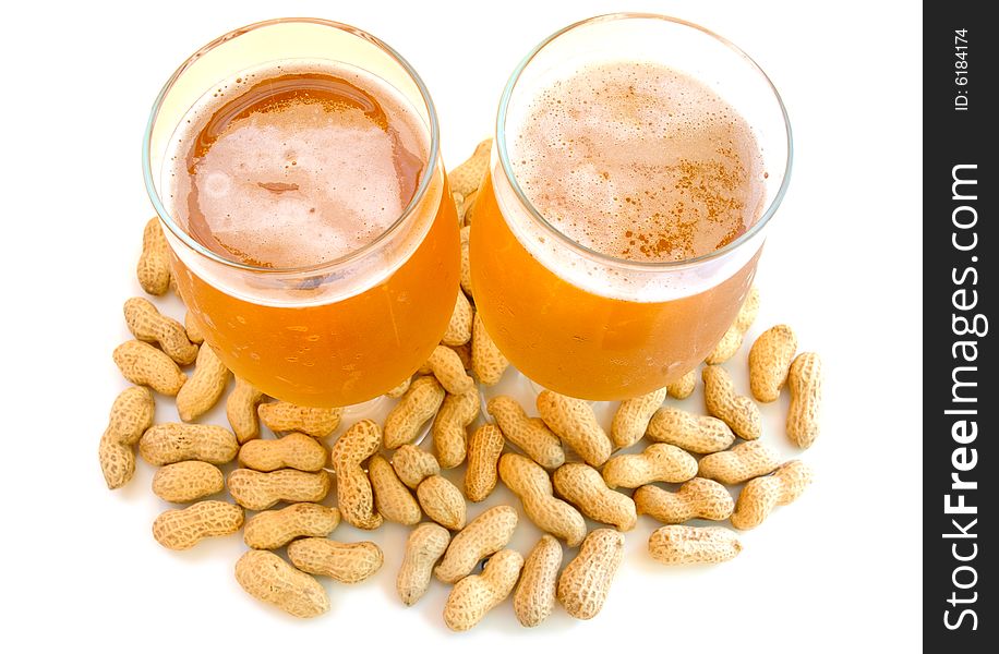 Beer in glass  and  snack - peanuts  in shells. Beer in glass  and  snack - peanuts  in shells.