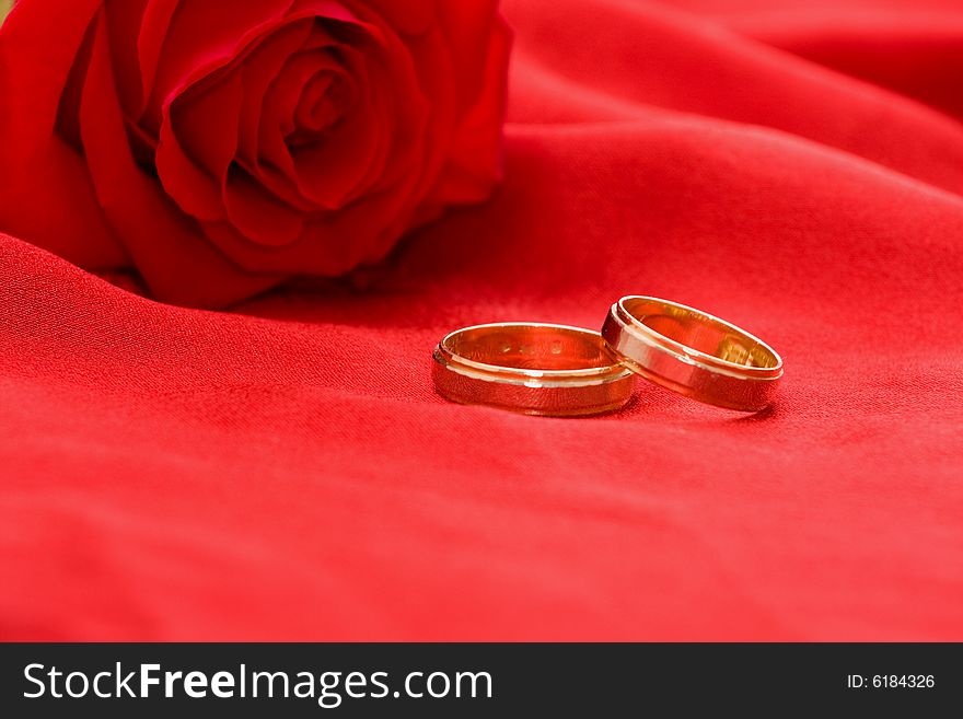 Wedding rings and red rose