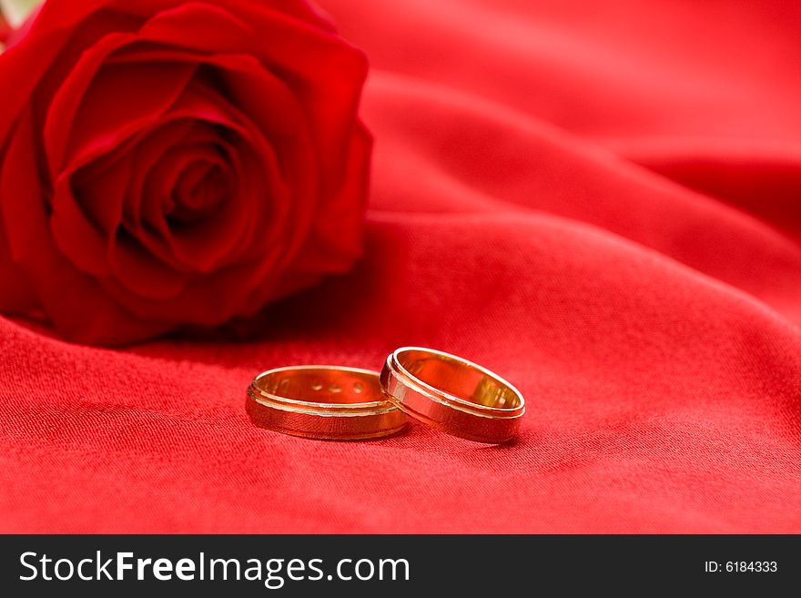 Wedding rings and red rose