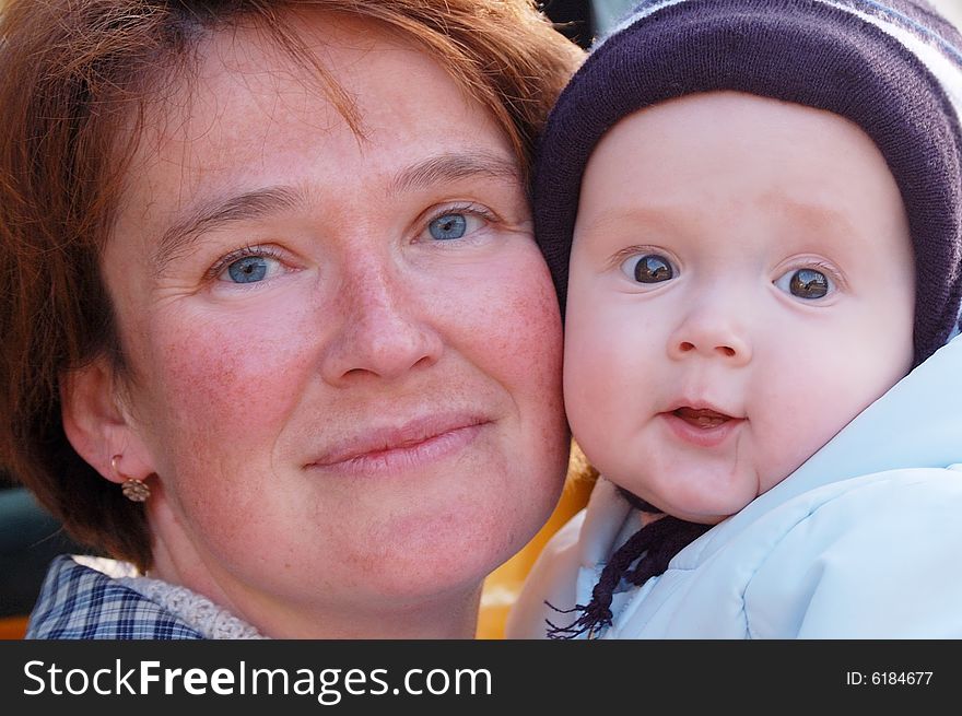 Mother and baby look in camera