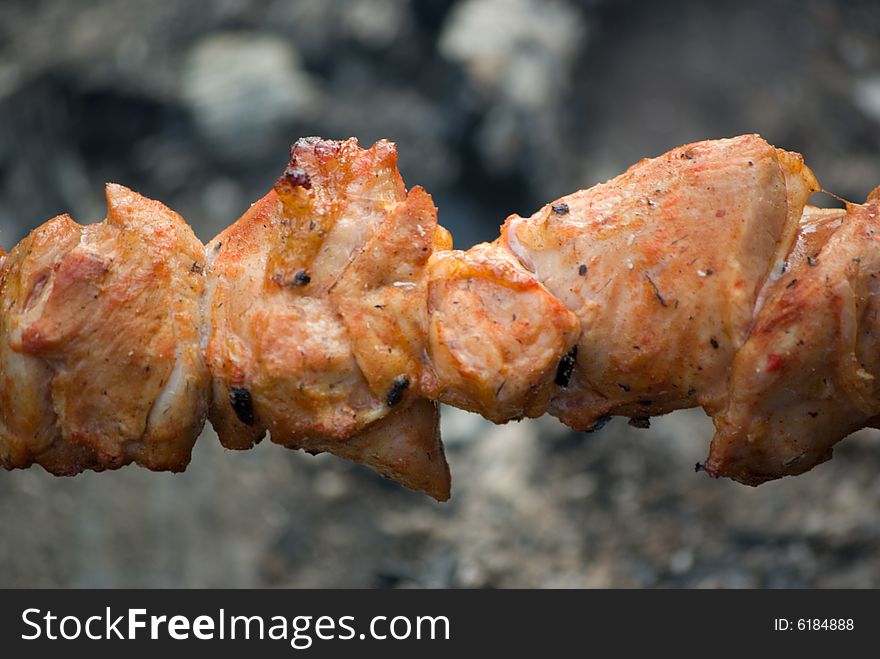 A fried meat on coals