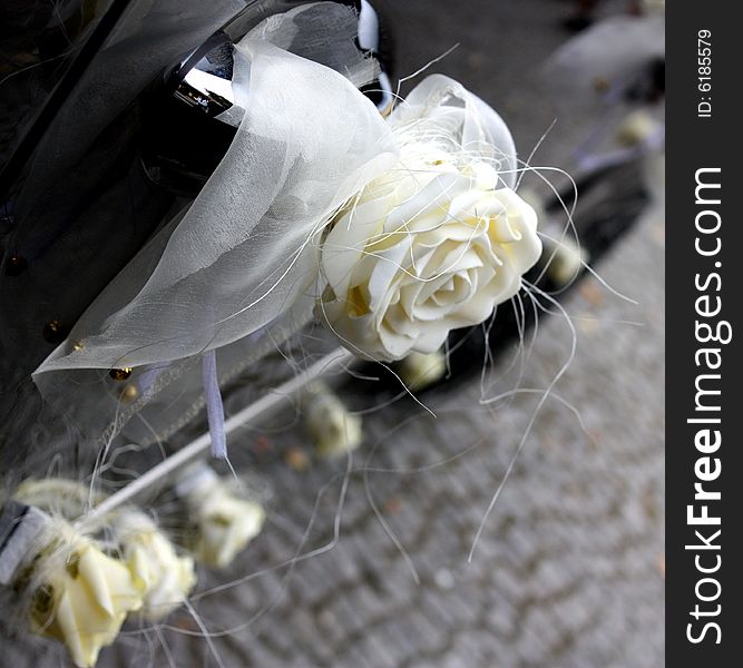 Black limousine with white roses waiting for just married couple. Black limousine with white roses waiting for just married couple.
