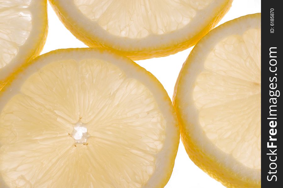Sliced lemons in cross section back lit and slightly translucent. Sliced lemons in cross section back lit and slightly translucent