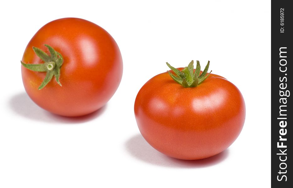 Two vibrant tomatoes on white background. Two vibrant tomatoes on white background