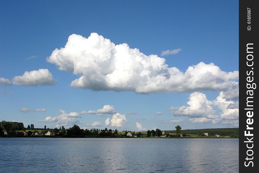 View of river with clouds in the sky at sunset