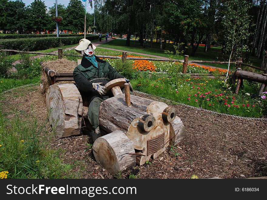 Wooden tractor in a flower bed