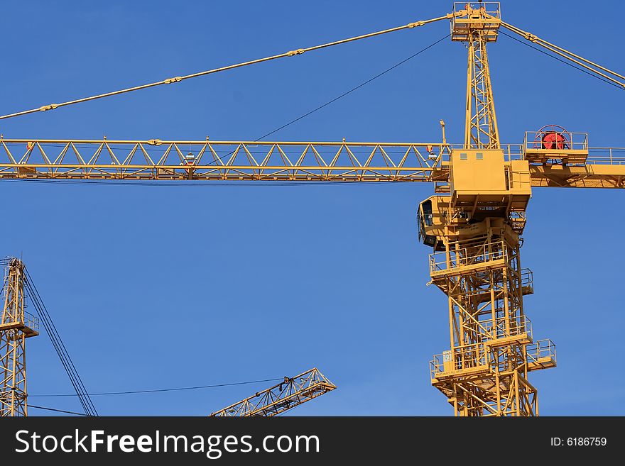 Yellow crane on a blue sky background