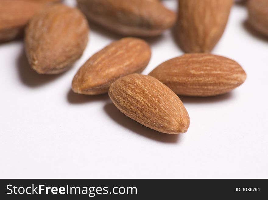 Almonds close up on white background with selective focus