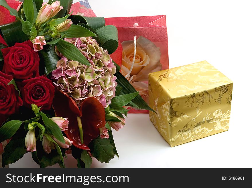 A gift box, a bag and  luxury bouquet isolated on white background. A gift box, a bag and  luxury bouquet isolated on white background