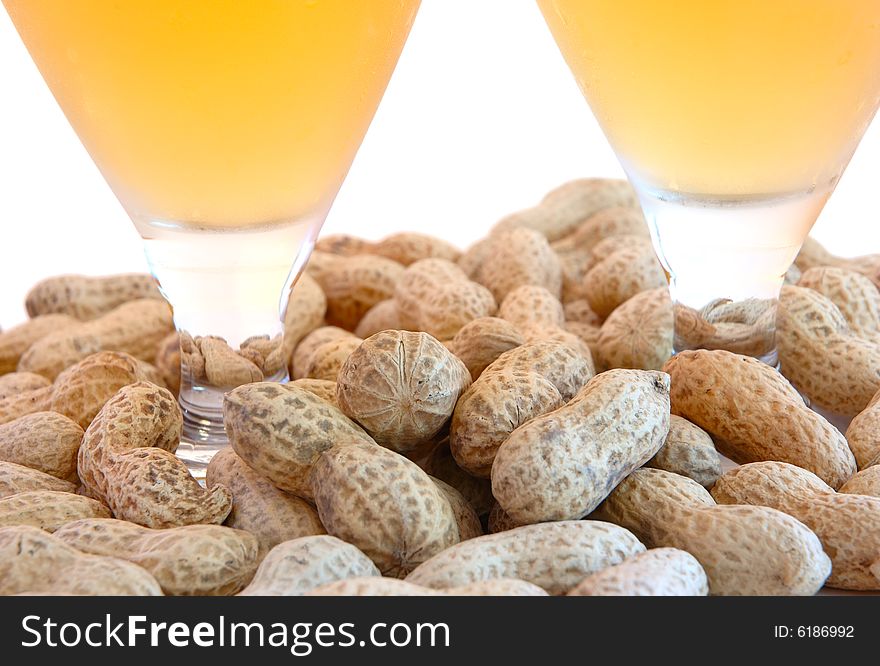 Beer in glass  and  snack - peanuts  in shells. Beer in glass  and  snack - peanuts  in shells.