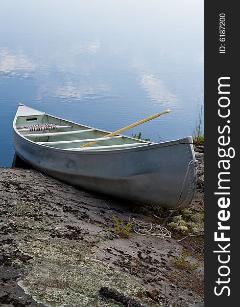 A lone canoe sitting on a rocky shore in Northern Ontario.