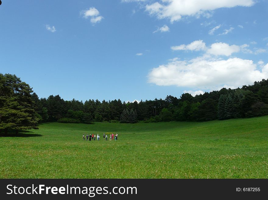 Group of people playing on the meadow