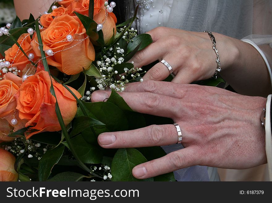Nice orange roses from the wedding and hands. Nice orange roses from the wedding and hands