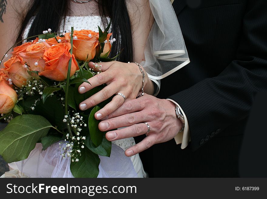 Nice orange roses from the wedding and hands. Nice orange roses from the wedding and hands