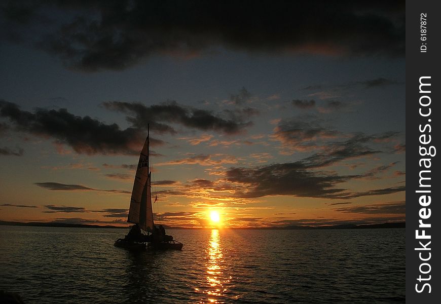 Sailboat At Sunset