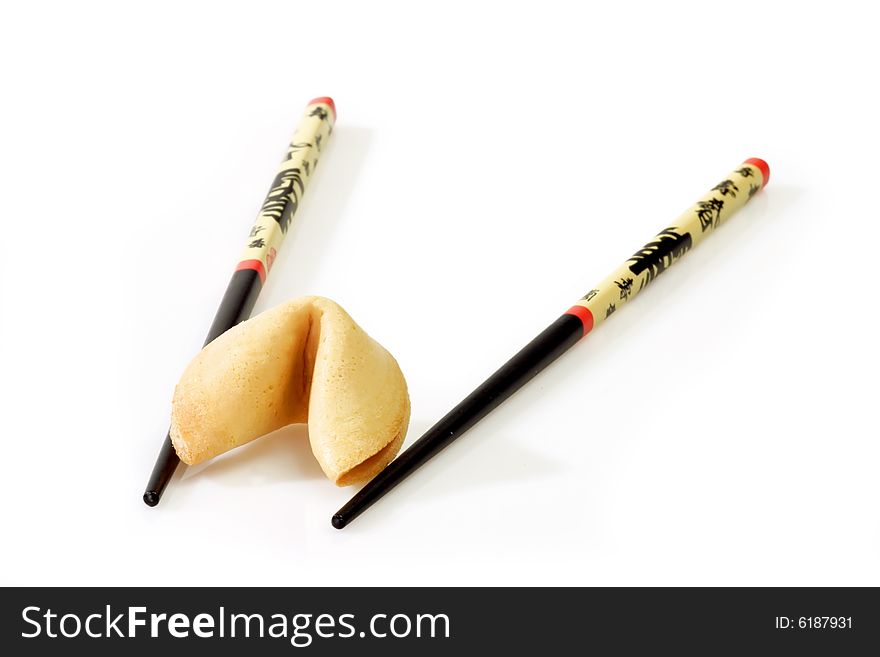 Fortune Cookie with Chopsticks on bright Background