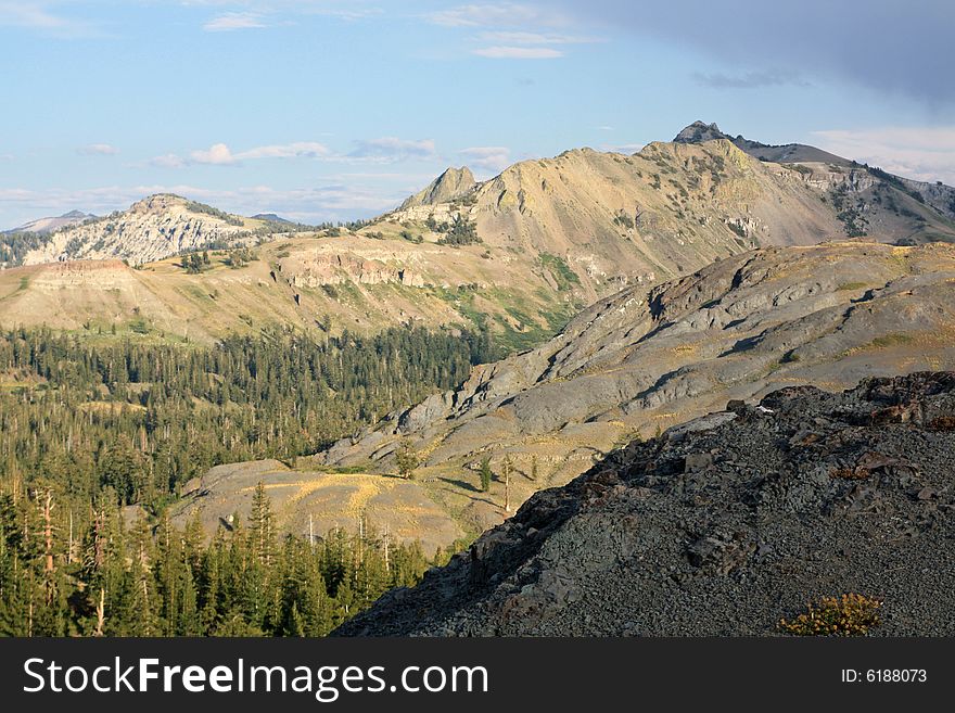 A rock ledge overlooking mountains and forests in the Sierra Nevadas.  California, U.S.A. A rock ledge overlooking mountains and forests in the Sierra Nevadas.  California, U.S.A.