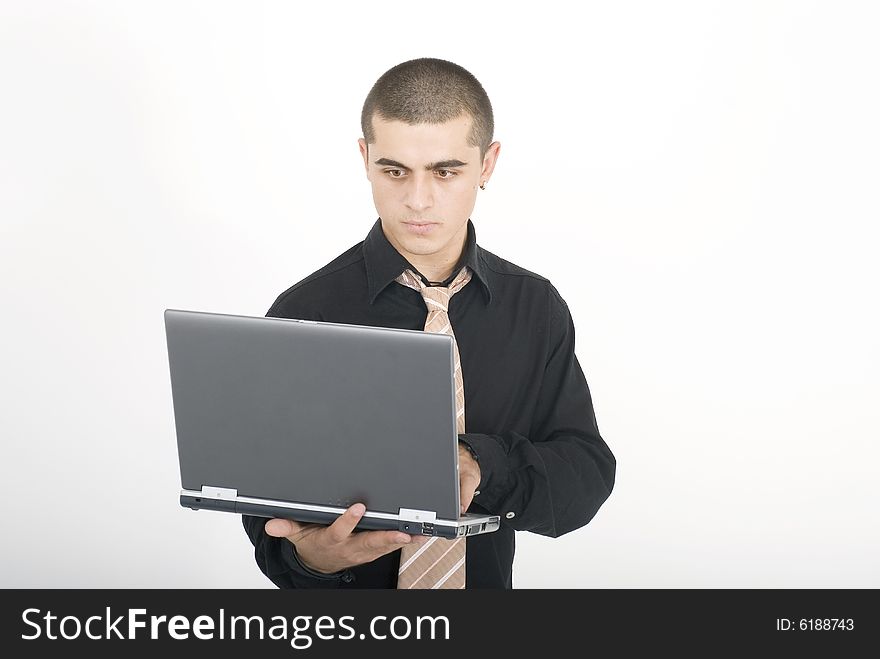 Young man in office with laptop. Young man in office with laptop