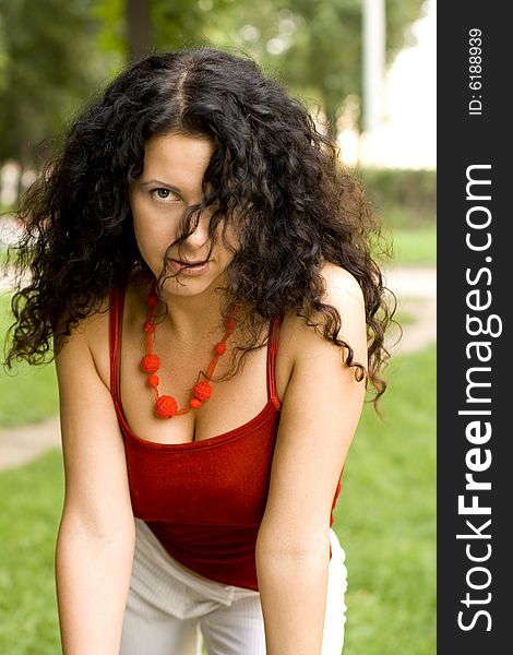 Outdoor portrait of beautiful brunet woman in red