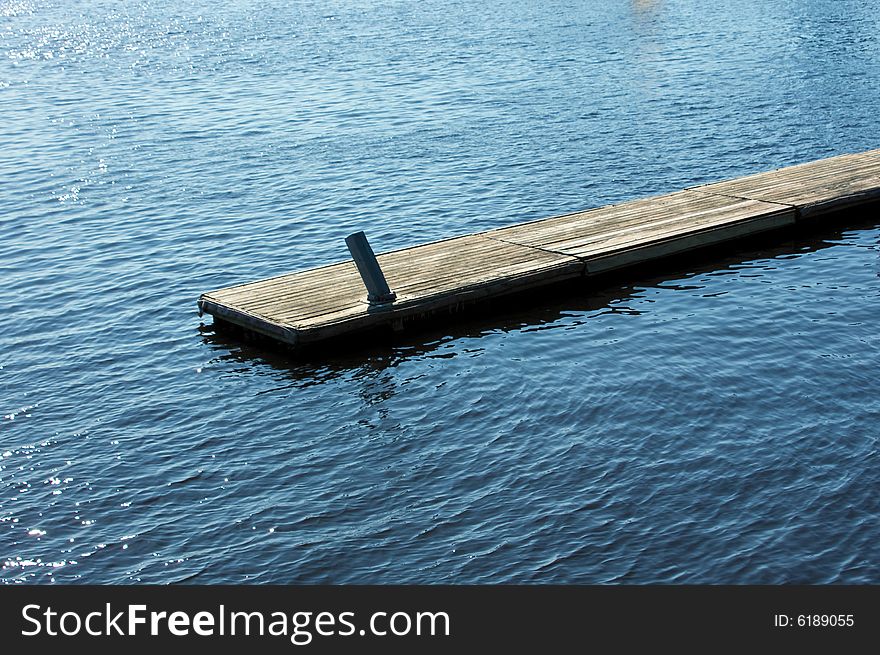 Long wooden Pier sticking out into the open water. Long wooden Pier sticking out into the open water