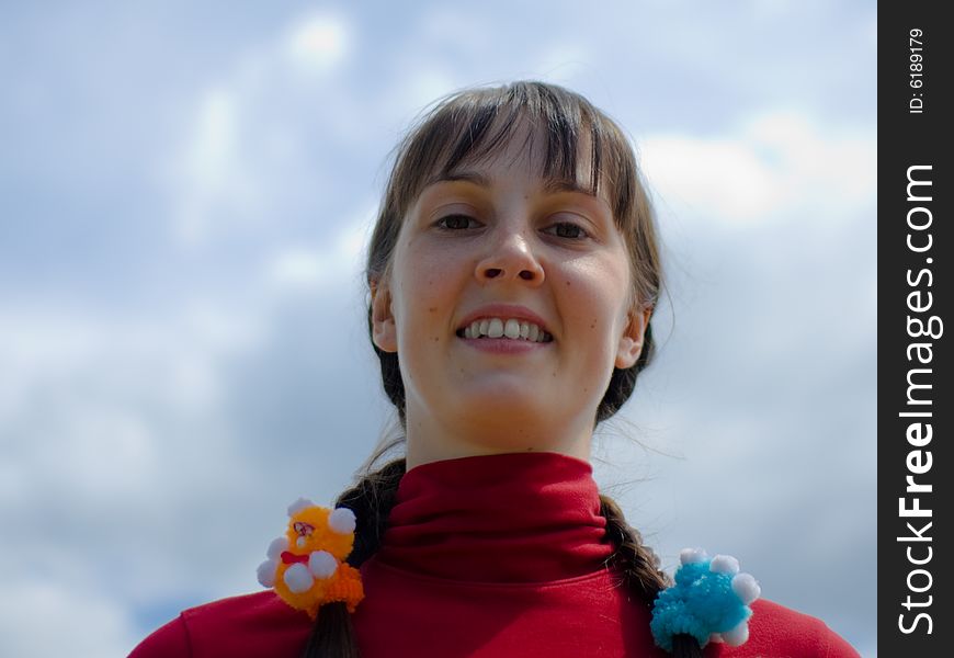 Smiling girl on the sky background