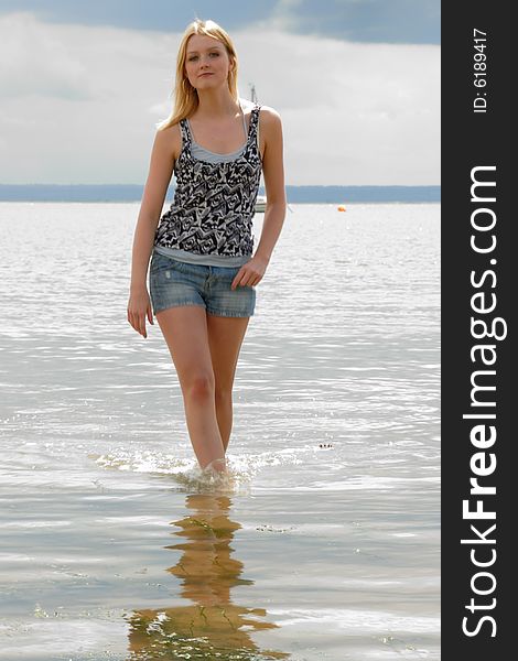 Close up portrait of cute young lady with straight blond hair at seaside. Close up portrait of cute young lady with straight blond hair at seaside