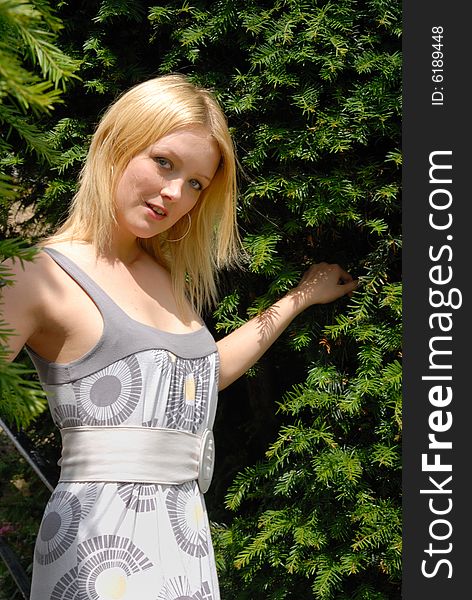 Cute young blond lady in garden