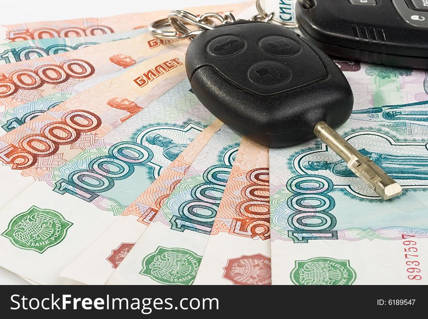 Car keys and money on a white background