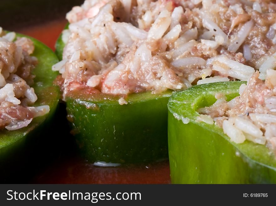 Stuffed peppers cut in to slices with tomato sauce