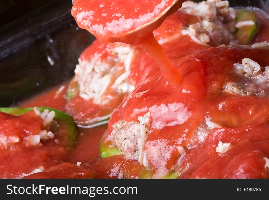 Stuffed peppers cut in to slices with tomato sauce