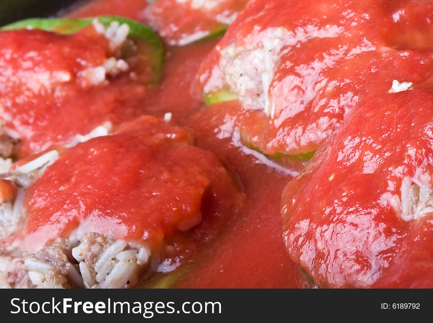 Stuffed peppers cut in to slices with tomato sauce