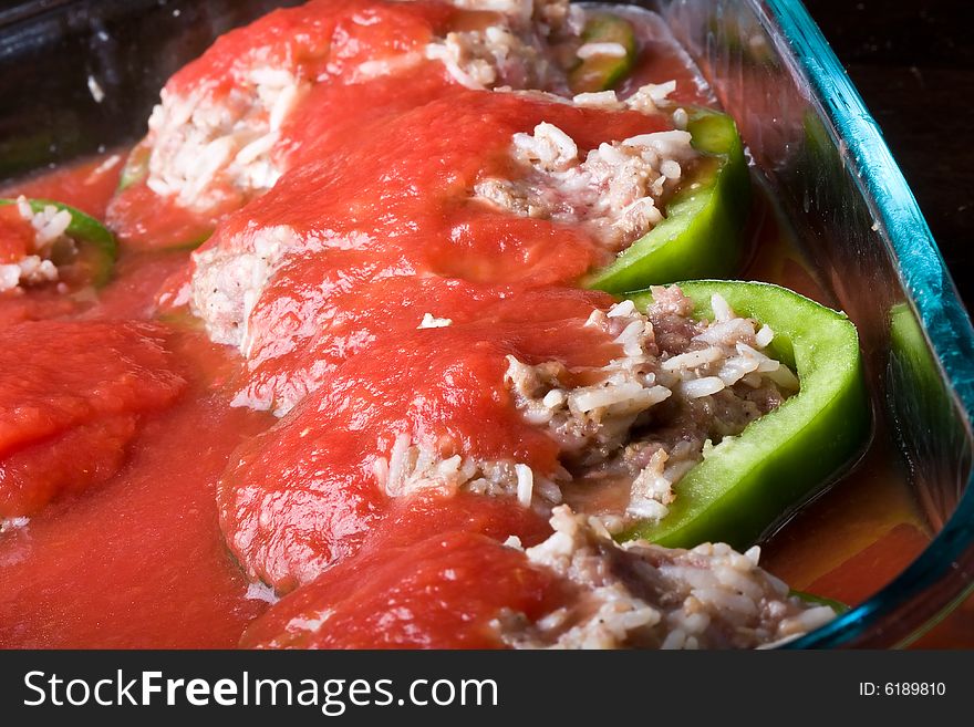 Stuffed peppers cut in to slices with tomato sauce