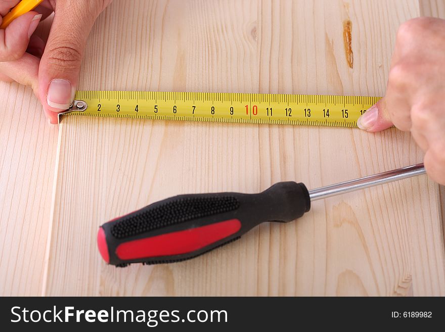 Closeup shot of wooden plank and measuring tape