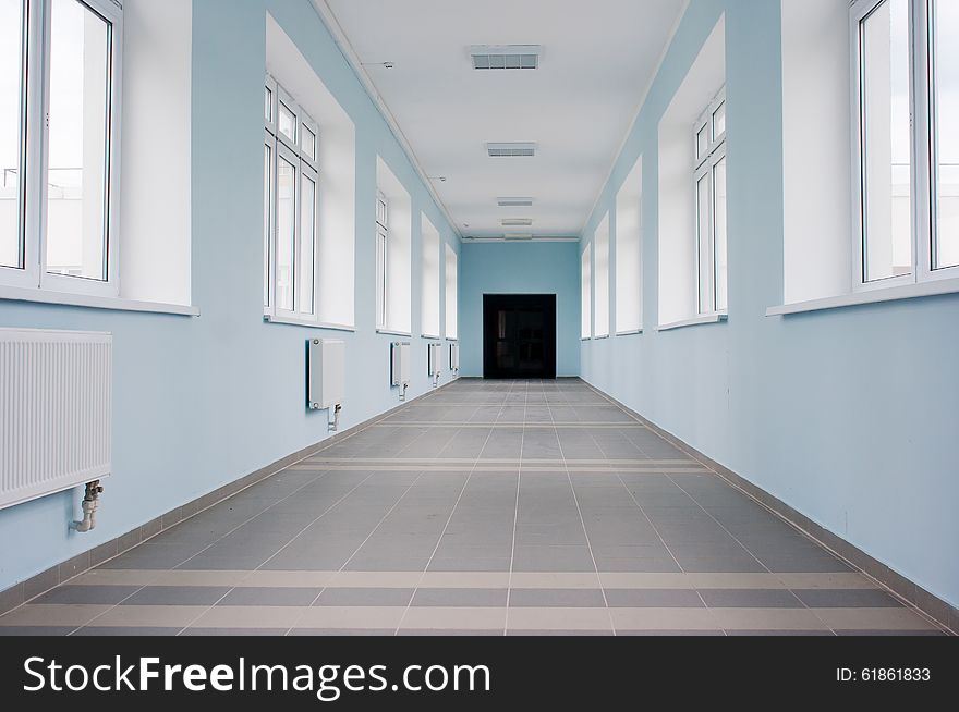 Long empty light hall in office building. Long empty light hall in office building