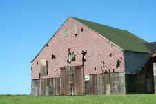 Old Barn With Grass And Blue Sky Stock Photo